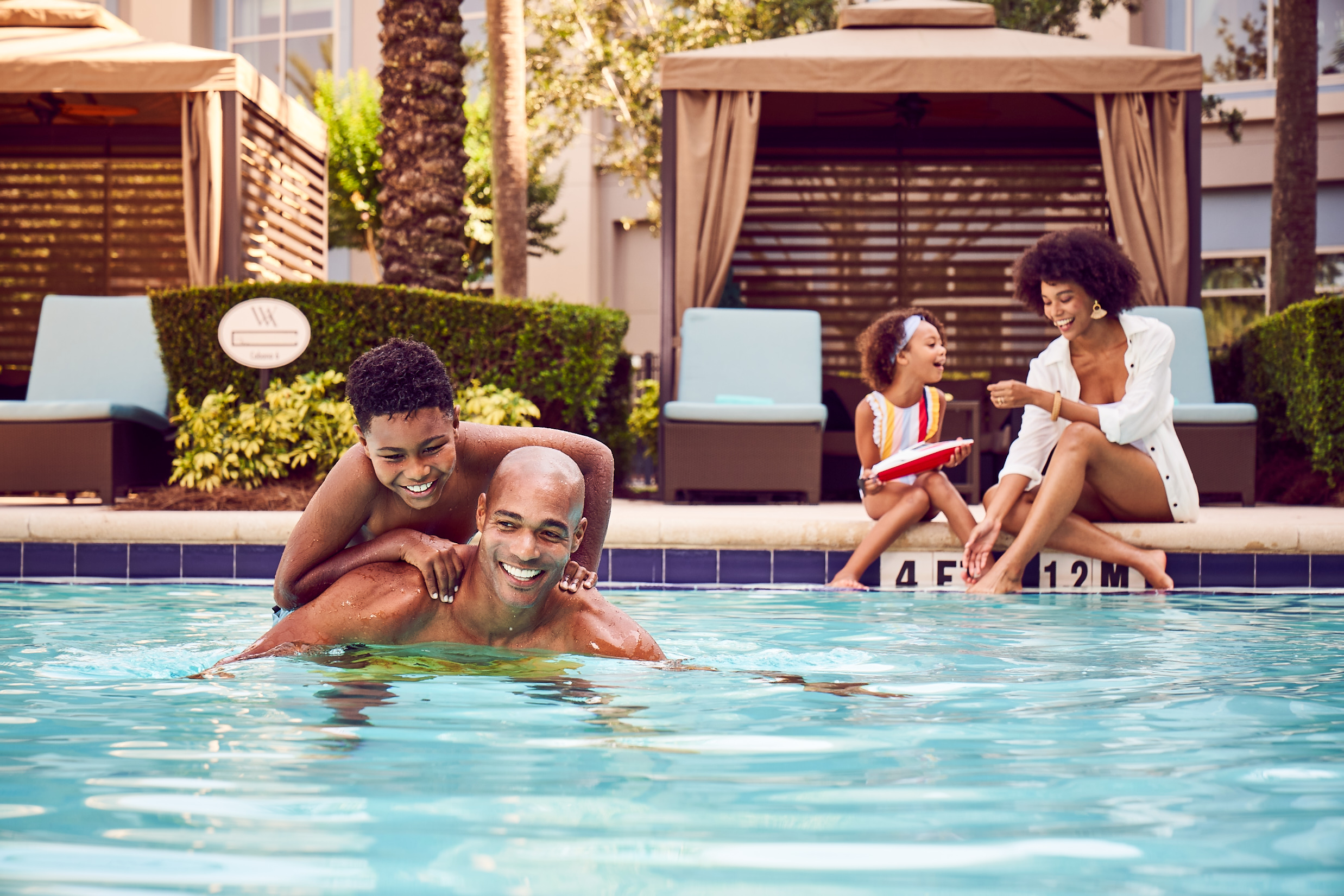 Family enjoying poolside cabana